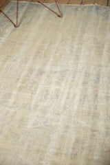 Textured pile of vintage distressed Oushak carpet, showing even wear and faint foundation.