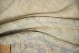 Hand knotted Oushak rug foundation, showing distressed beige and faded pastel pile.