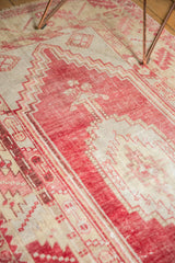 Distressed Oushak rug main border with serrated leaf pattern in pale cochineal red and ivory.