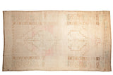 Distressed vintage Oushak rug, pale abrashed field, double stepped medallion, light pink, ivory.