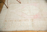 Distressed low pile of vintage Oushak with an abrashed field of pale pink and powder blue.