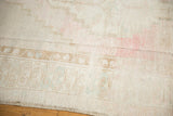 Faded stepped contour and distressed low pile of a vintage Oushak rug.