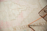 Pale blush and platinum abrash on distressed low pile of vintage Oushak rug.