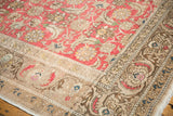 Distressed vintage Sivas rug's ornate beige border and worn blush Herati field.