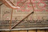 Distressed vintage Sivas carpet's detailed border, worn fringe, and blush motif.