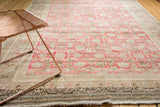 Distressed vintage Sivas rug border with soft blush, beige patterns, and delicate fringe.