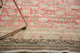 Vintage Sivas rug showing distressed fringe and floral border with blush and beige tones.