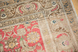 Distressed pile texture showing deep blush Herati motif and intricate beige border.