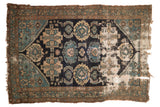 Antique Malayer fragment rug, navy, dusty teal, ivory, with large geometric motifs and extensive wear, 4x6 ft.