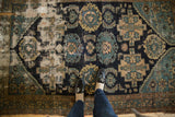 Antique Malayer rug detail: storied hard wear, visible foundation, navy and teal palmettes.
