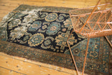 Antique Malayer rug detail: oversized palmettes, Herati motif in navy, teal, ivory, threadbare, tattered perimeter.