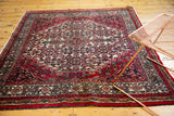 Hand-knotted Persian Bibikabad square carpet's cherry red, ivory, and navy Herati pattern.