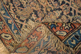 Folded Antique Kurdish rug revealing hand-knotted foundation, tattered fringe, and worn pile.