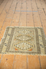 Antique Caucasian mat seen lengthwise, detailing the serpent border surrounding the central geometric guls.