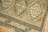 Geometric serpent border and low, even pile on the corner of an antique Caucasian rug.
