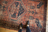 Vintage West Persian rug with asymmetric concentric medallion, geometric patterns in brick red, navy, dusty teal and even wear.