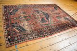 Hand-knotted Vintage West Persian rug, pale brick red field, bold asymmetric navy blue medallion.