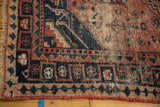 Vintage West Persian rug's secured edge with navy, brick red geometric patterns, and wear.
