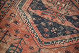 Vintage West Persian rug with bold geometric patterns in navy blue, pale brick red, and dusty teal.