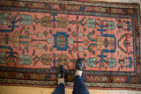 Lilihan rug's dusty blush field features large finned floral, cloudband, geometric patterns.