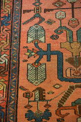 Finned floral design and indigo vinery on dusty blush field of a vintage Lilihan rug.