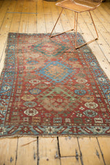 Characteristic aged fringe and geometric border of the early 20th century Caucasian rug.