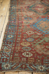 Antique Caucasian rug's sky blue border with geometric motifs, and the aged hand-knotted selvage.