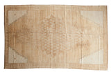 Vintage Distressed Oushak rug, oversized lattice medallion, floral perimeter, pale coffee and silver.
