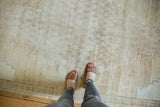 Distressed vintage Oushak rug's faint lattice and floral motifs in soft platinum and pale brown.
