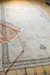 Distressed vintage Oushak carpet with faded field motifs and rams horn geometric border.