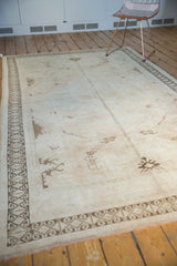 Pale coffee brown rams horn border on distressed vintage Oushak rug.