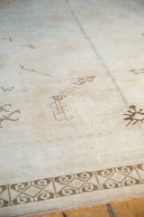 Distressed geometric rams horn border of a vintage Turkish Oushak carpet.