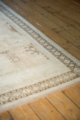 Vintage distressed Turkish Oushak rug with pale geometric motifs and brown ram's horn border.