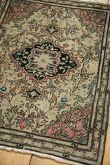 Ivory fringe and charcoal border detail delicate blush floral vinery on this antique Farahan Sarouk rug.