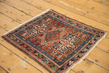 Vintage Karaja rug's geometric pattern in brick red, blue, and ivory with fringe.
