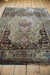 Antique Mohtashem Kashan rug's intricate aubergine border and gem-tone floral field with fringe detail.