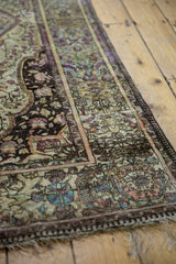 Finely woven silk fringe and intricately patterned border of an antique Kashan rug.