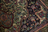 Finely woven antique silk Kashan rug detail, showcasing intricate floral vines and vibrant gem tones.