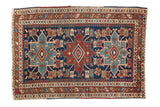 Antique Heriz rug, circa 1910s, with triple geometric medallions in navy, wine red, and sky blue.