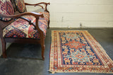 Geometric Karaja motif medallions and reciprocating pawn border on an antique Heriz rug.
