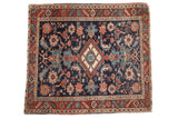 Antique hand-knotted Heriz square rug, navy field, diamond medallion, red floral palmettes.