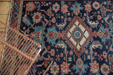 Antique Heriz rug, intricate diamond medallion, floral palmettes, navy, wine red, ivory palette.