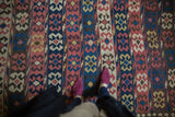 Antique Persian Kilim carpet's horizontal rows featuring crab design motifs in madder red, blue, and ivory.