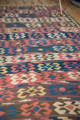 Hand woven Persian Kilim featuring alternating madder root red, blue, ivory geometric crab motifs.