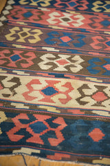 Geometric crab pattern in madder red, ivory, and blue on an Antique Persian Kilim.