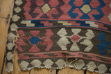 Heavily tattered edge detail of antique Persian Kilim, featuring madder red crab designs.