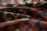 Hand woven Antique Persian Kilim detail, featuring madder red, ivory, and blue geometric crab motifs.