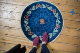 Art Deco round rug: cobalt blue field, scrolling pale green leaves, floral arabesques, lotus flower.