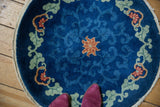 Chinese Art Deco rug: cobalt blue field, green vines, floral arabesque, tattered edge.