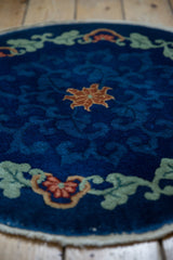 Chinese Art Deco rug with cobalt blue field, scrolling green vines and red floral arabesques.